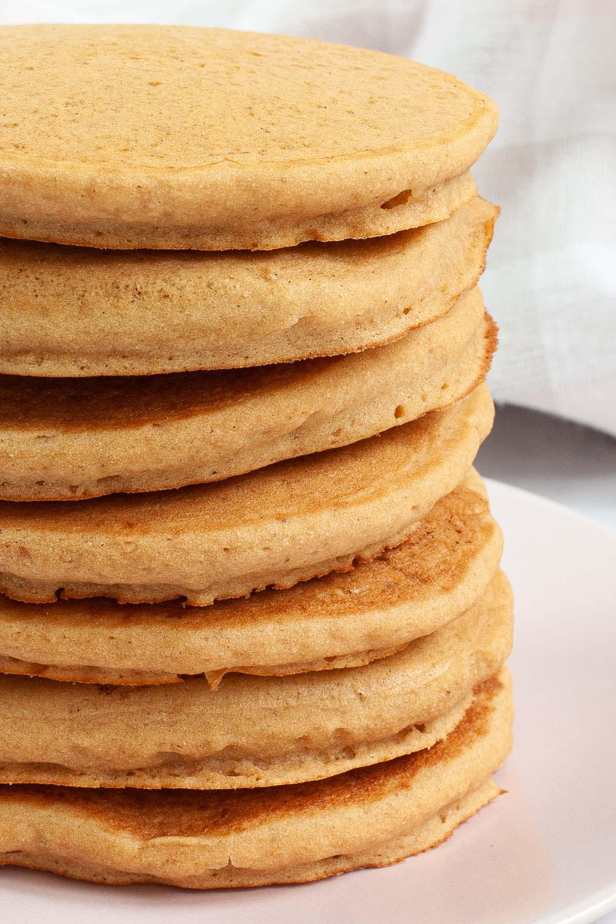 Pink plate with a stack of pancakes