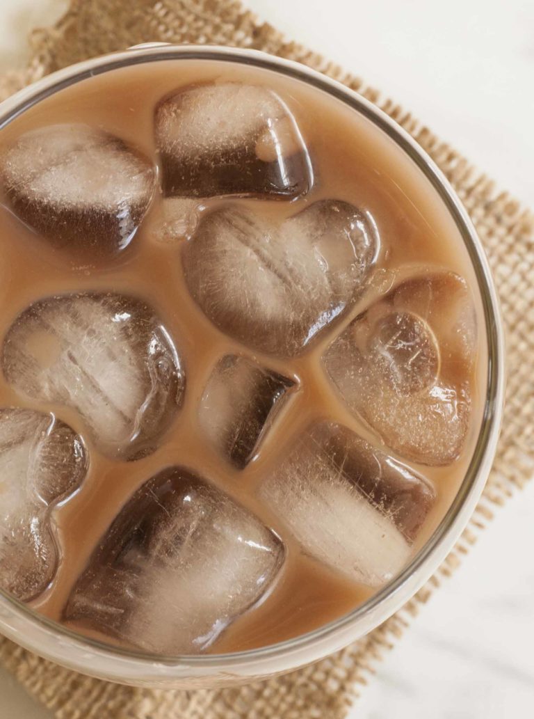 Close-up of a glass full of Vegan Baileys made of coffee, Irish whiskey, cane sugar, almond milk, and a bit of vanilla extract and cocoa powder.