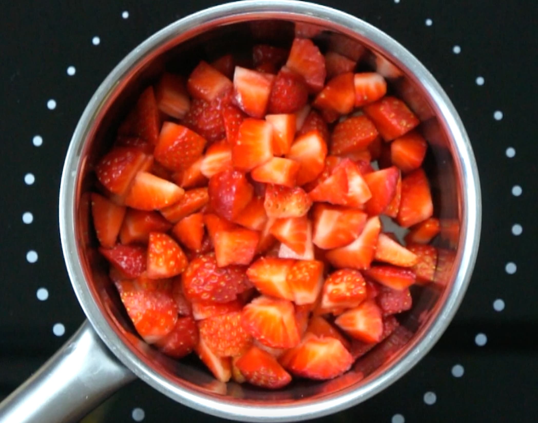 Strawberry pieces in a small saucepan. 