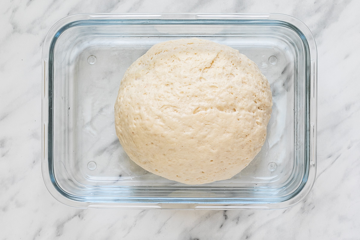 Glass container with a small ball of dough.