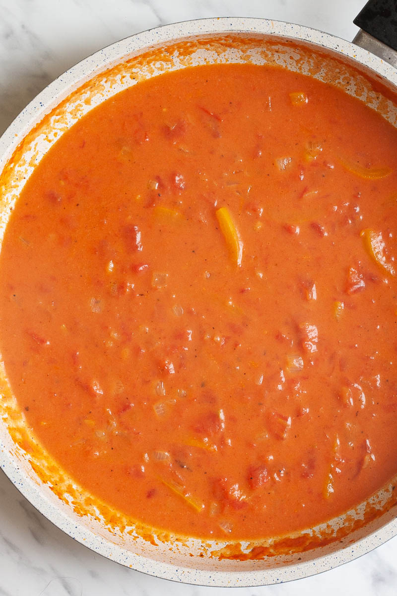 Orange red sauce in a frying pan from above