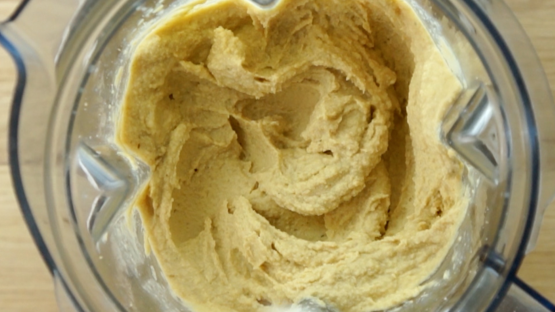 Blender with a smooth light brown hummus
