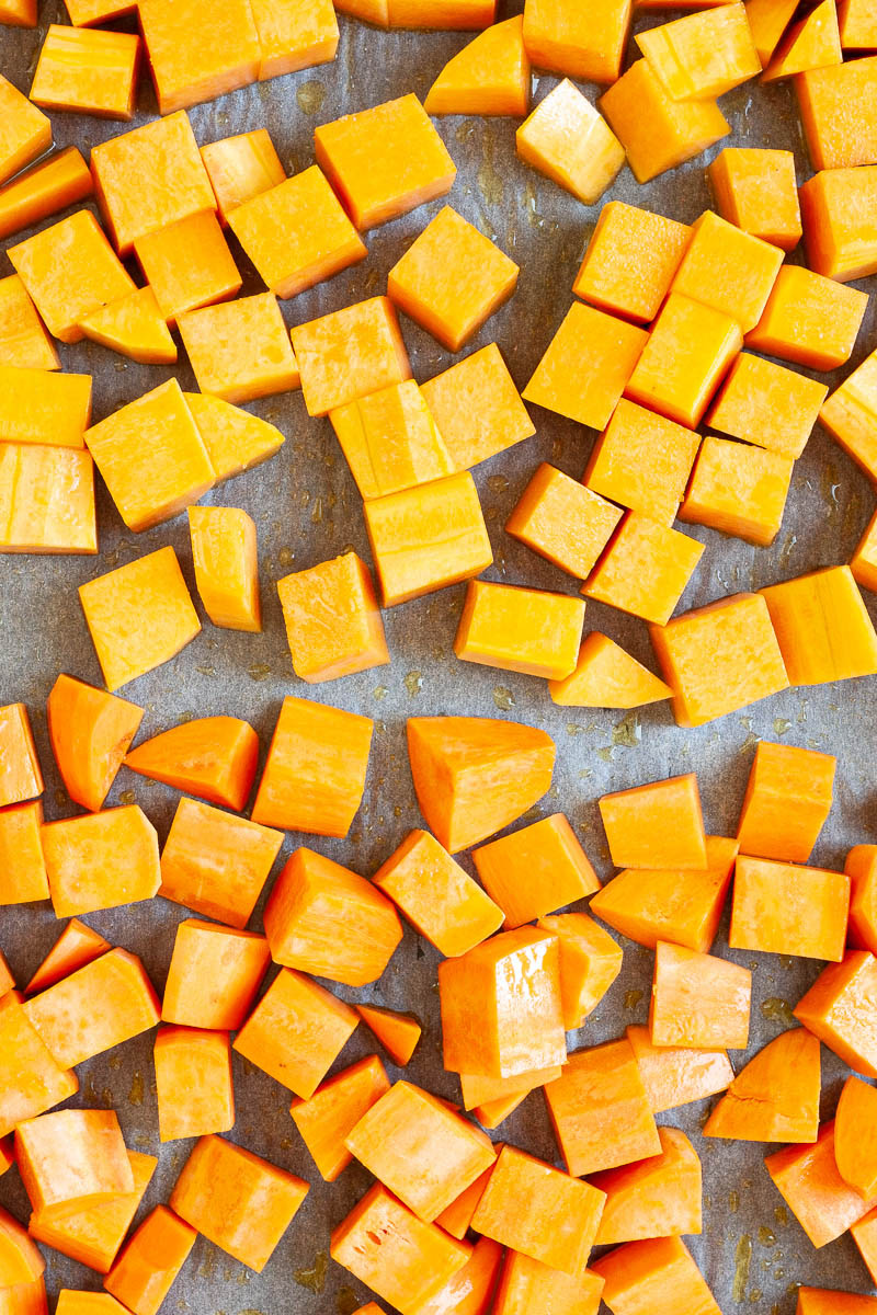 Diced orange sweet potato and pumpkin on a white parchment paper