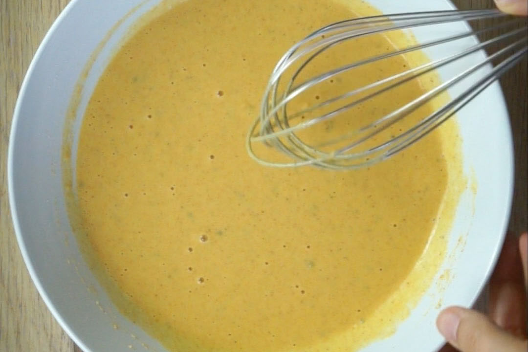 White bowl with yellow batter