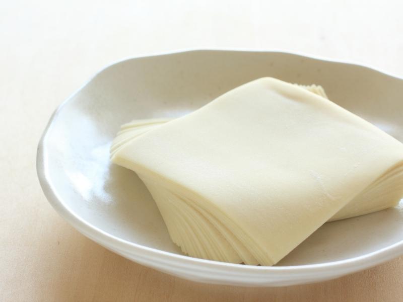 Square-shared dough sheets on a white plate