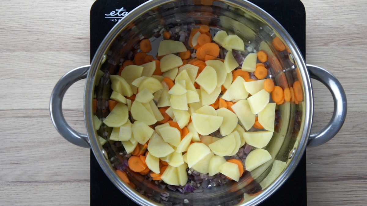 Sliced carrot and potatoes in broth.