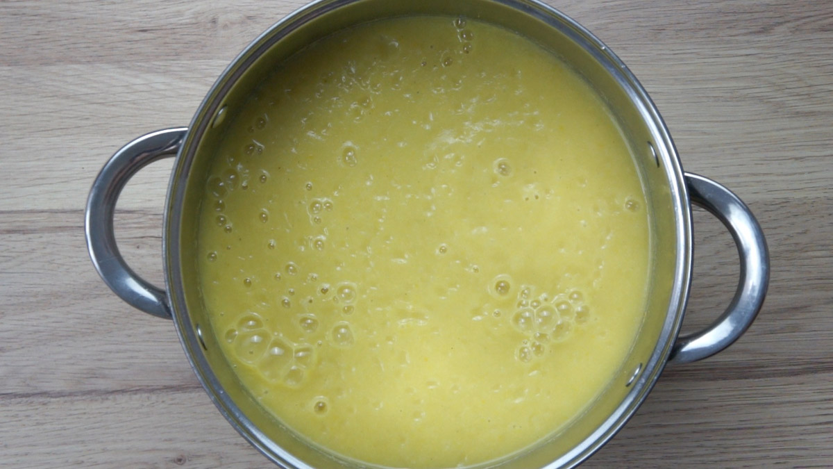 Yellow soup in pot.
