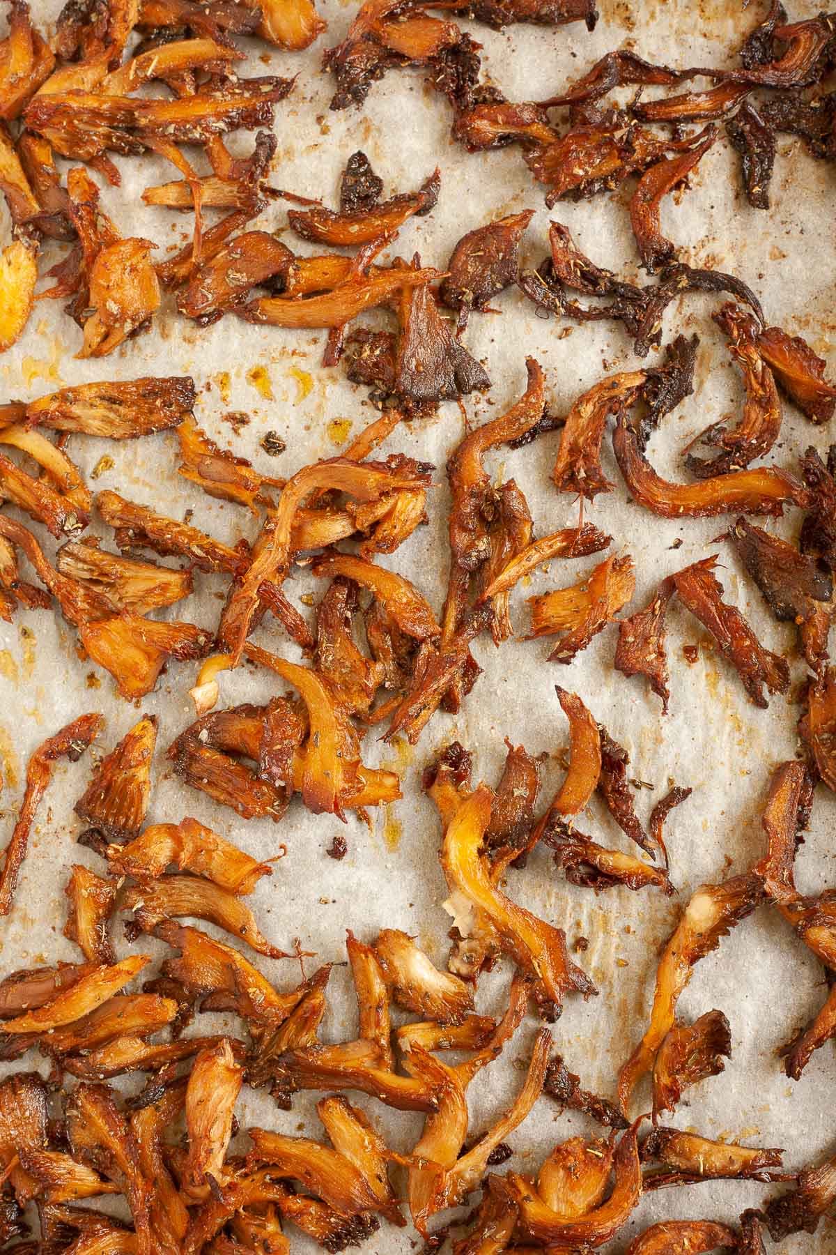 Brown crispy mushrooms strips  on parchment paper