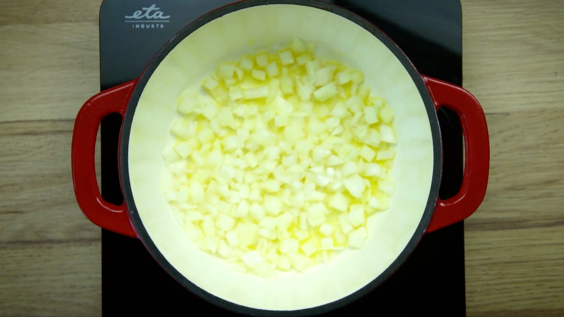 White stockpot with chopped onions. 