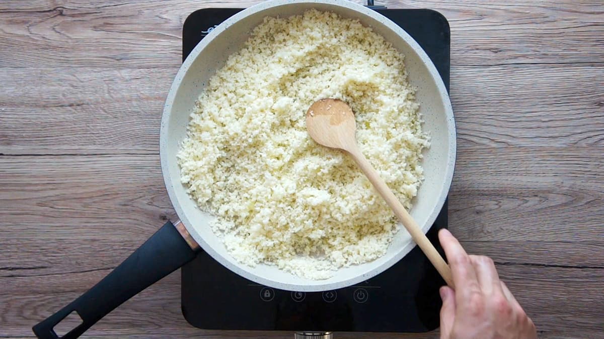 White frying pan with chopped cauliflower