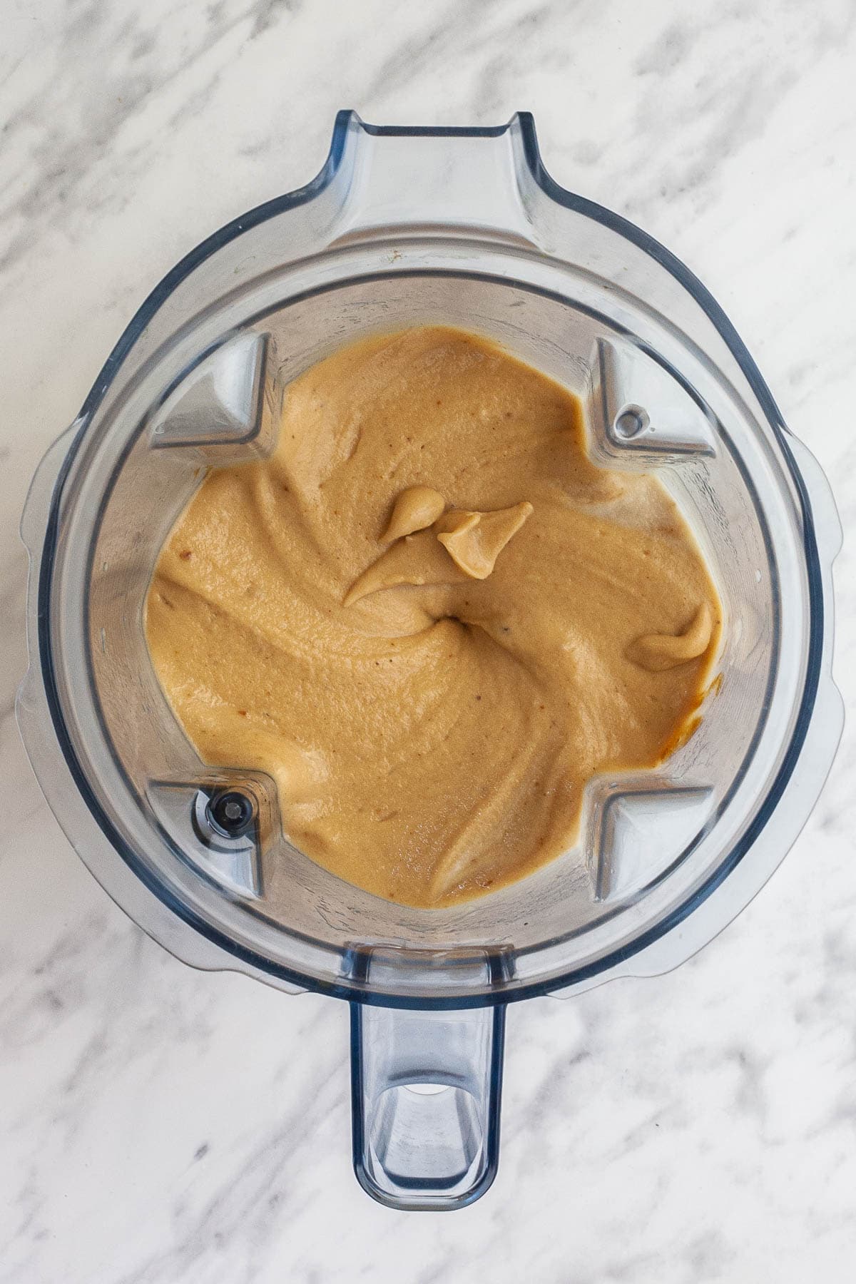 Blender from above with caramel colored ice cream