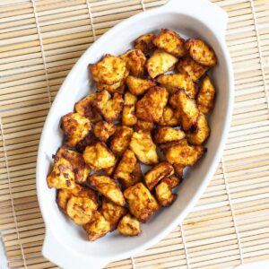 White bowl with yellow-brown tofu bites