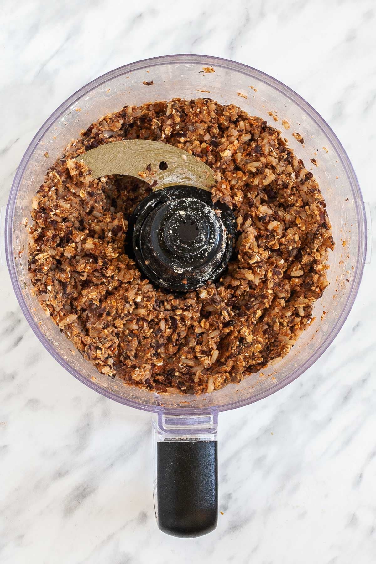 There is a brown crumbly textured mix in the food processor