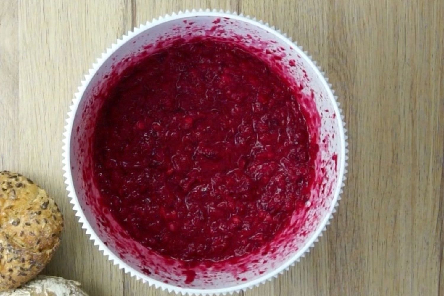 White mixing bowl with purple mixture for burger patties.