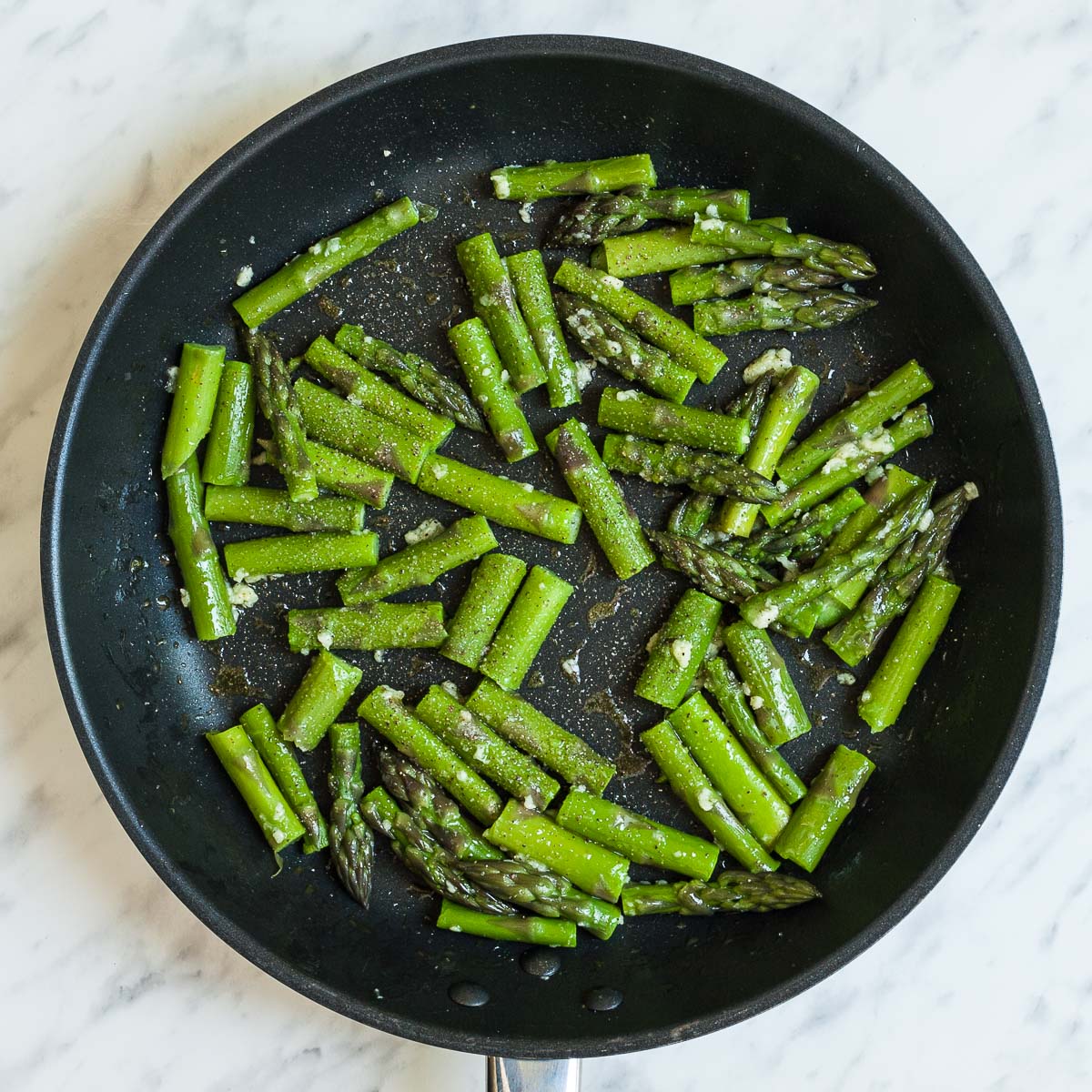 Black frying pan with asparagus.