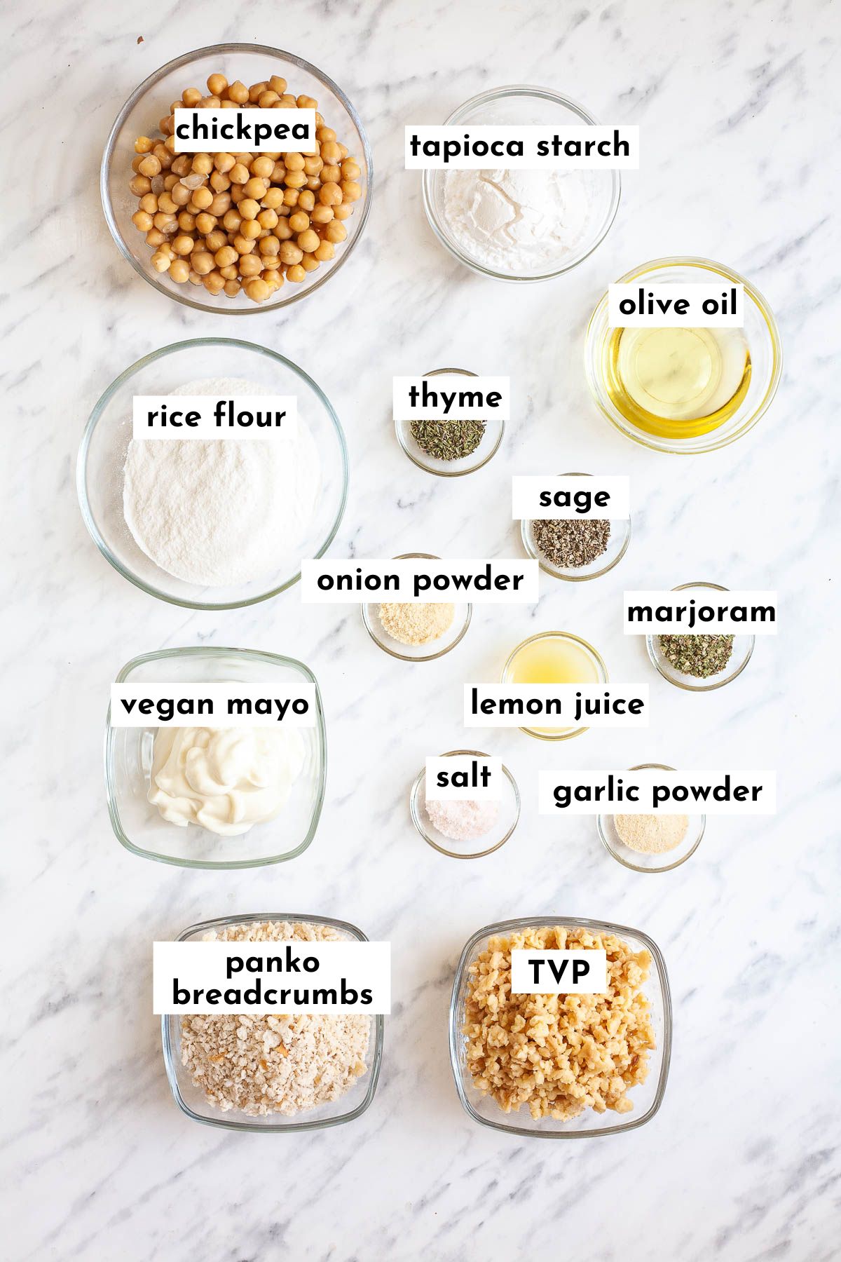 Ingredients of the vegan chicken patty in small glass bowls like chickpeas, tvp, breadcrumbs, flour, different spices, oil, lemon juice
