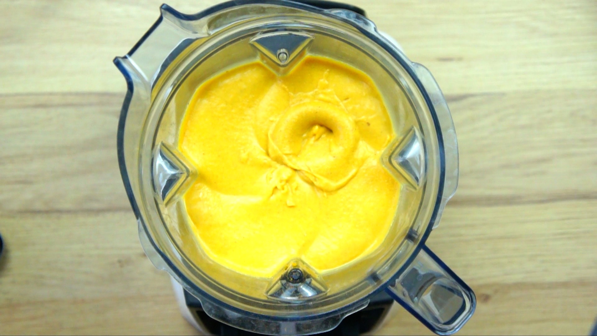 Blender with smooth orange sauce.