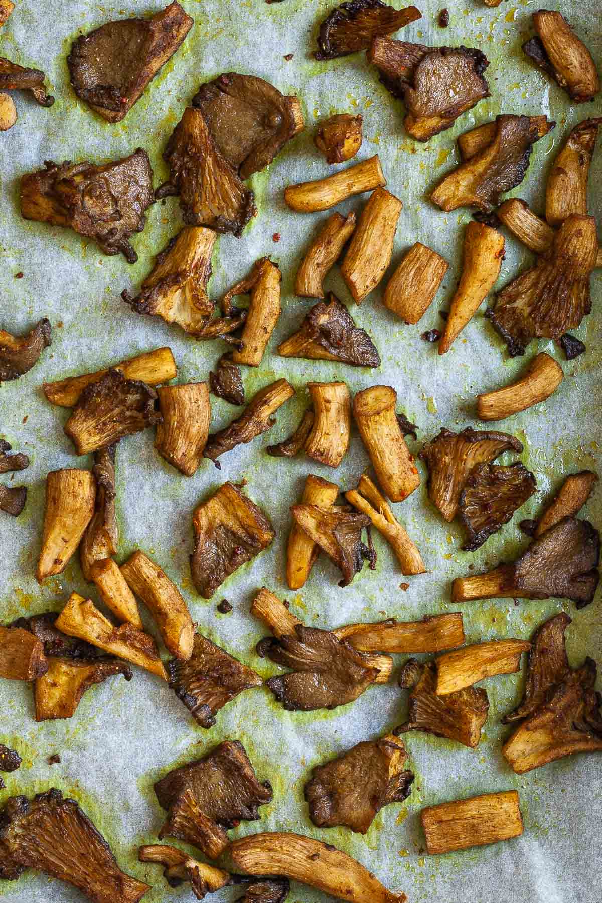 Brown mushroom shreds after baking with crispy edges.