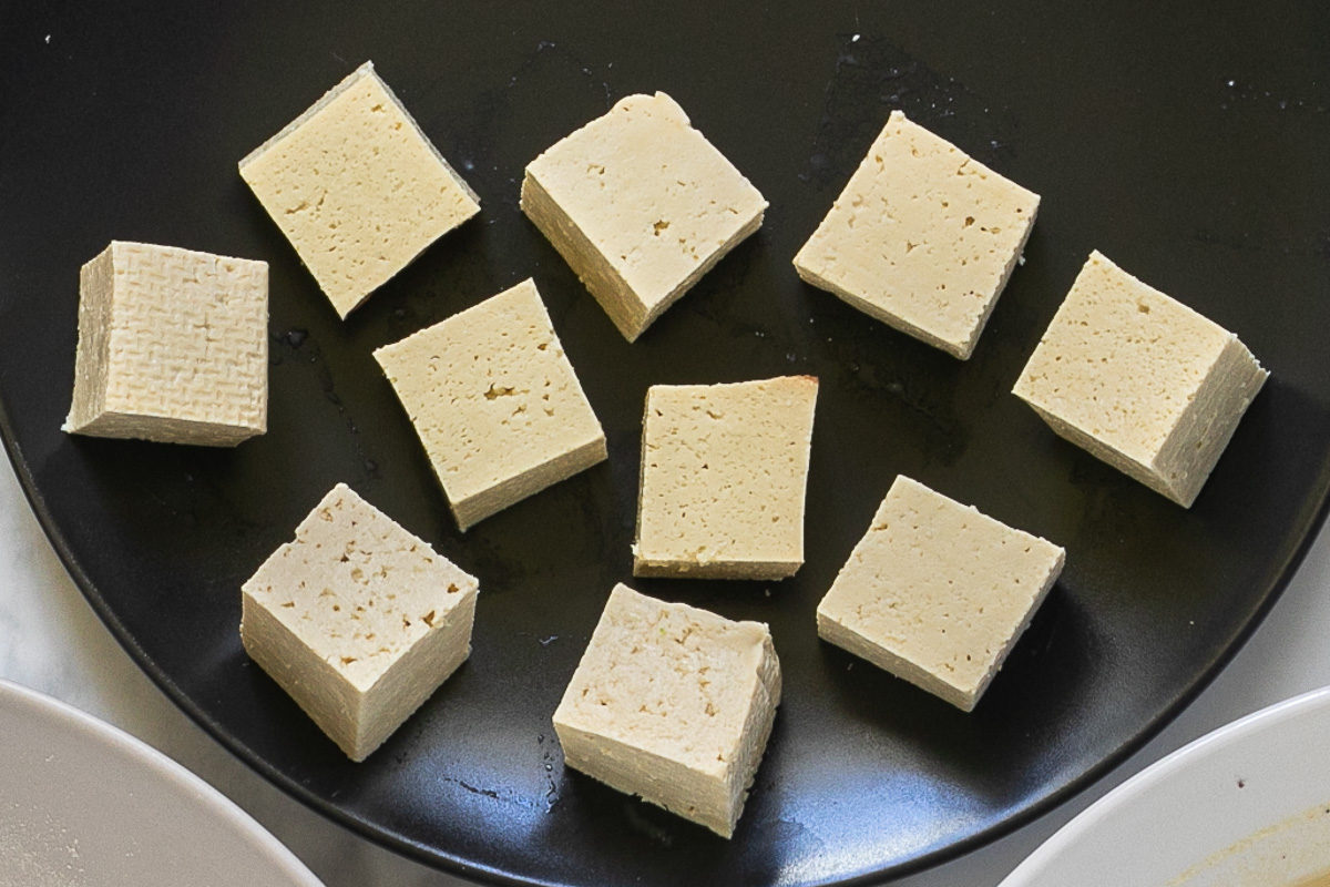 White tofu cubes on a black plate