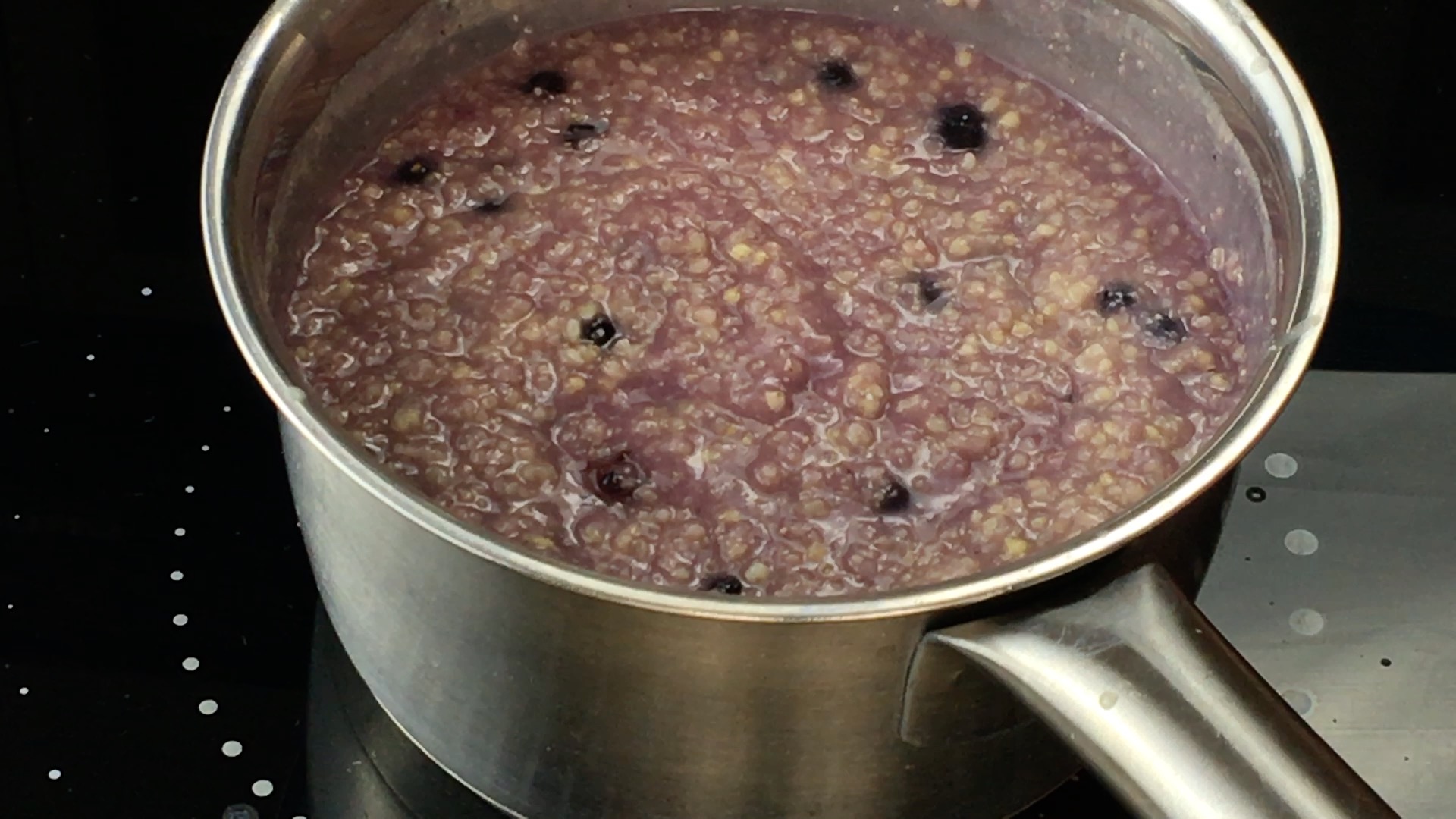 Purple porridge with blueberries in it.