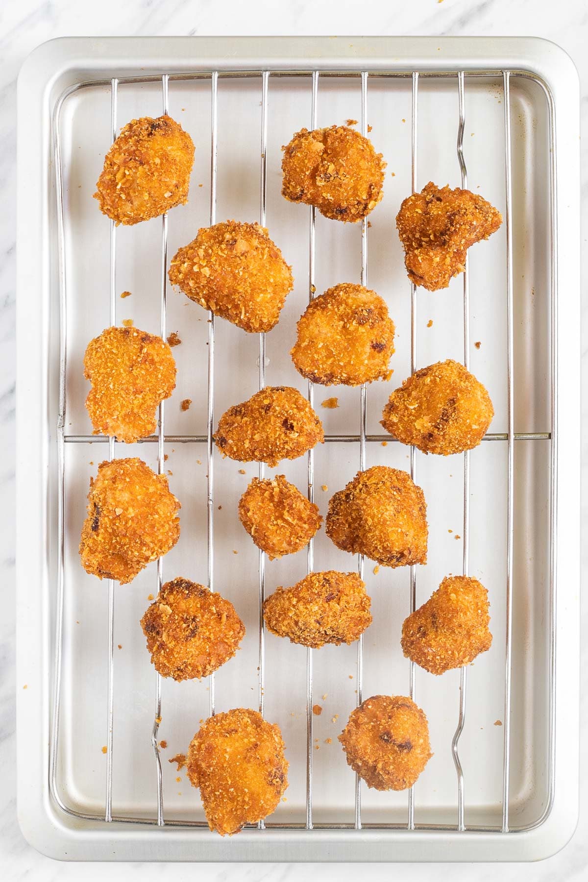 Crispy breaded cauliflower florets on a grill rack