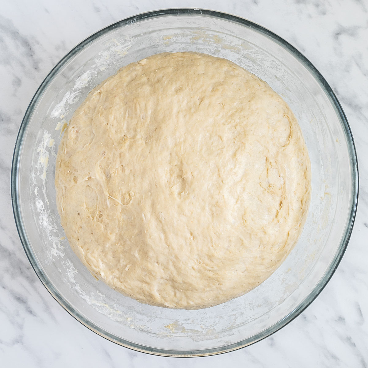 Glass bowl with a huge ball of dough.