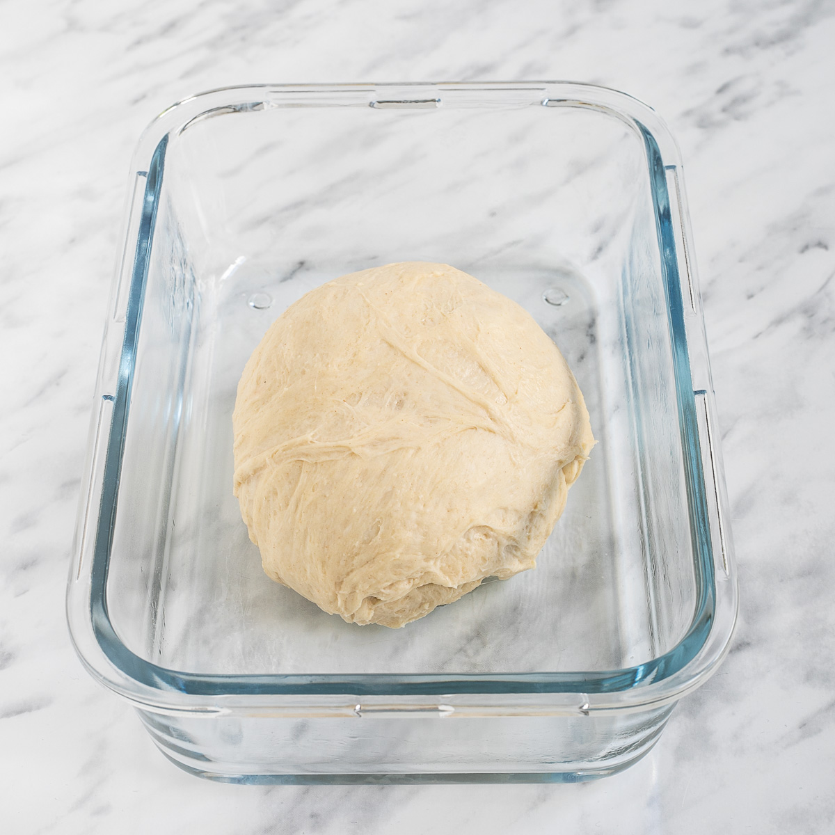 Glass container with a small ball of dough.
