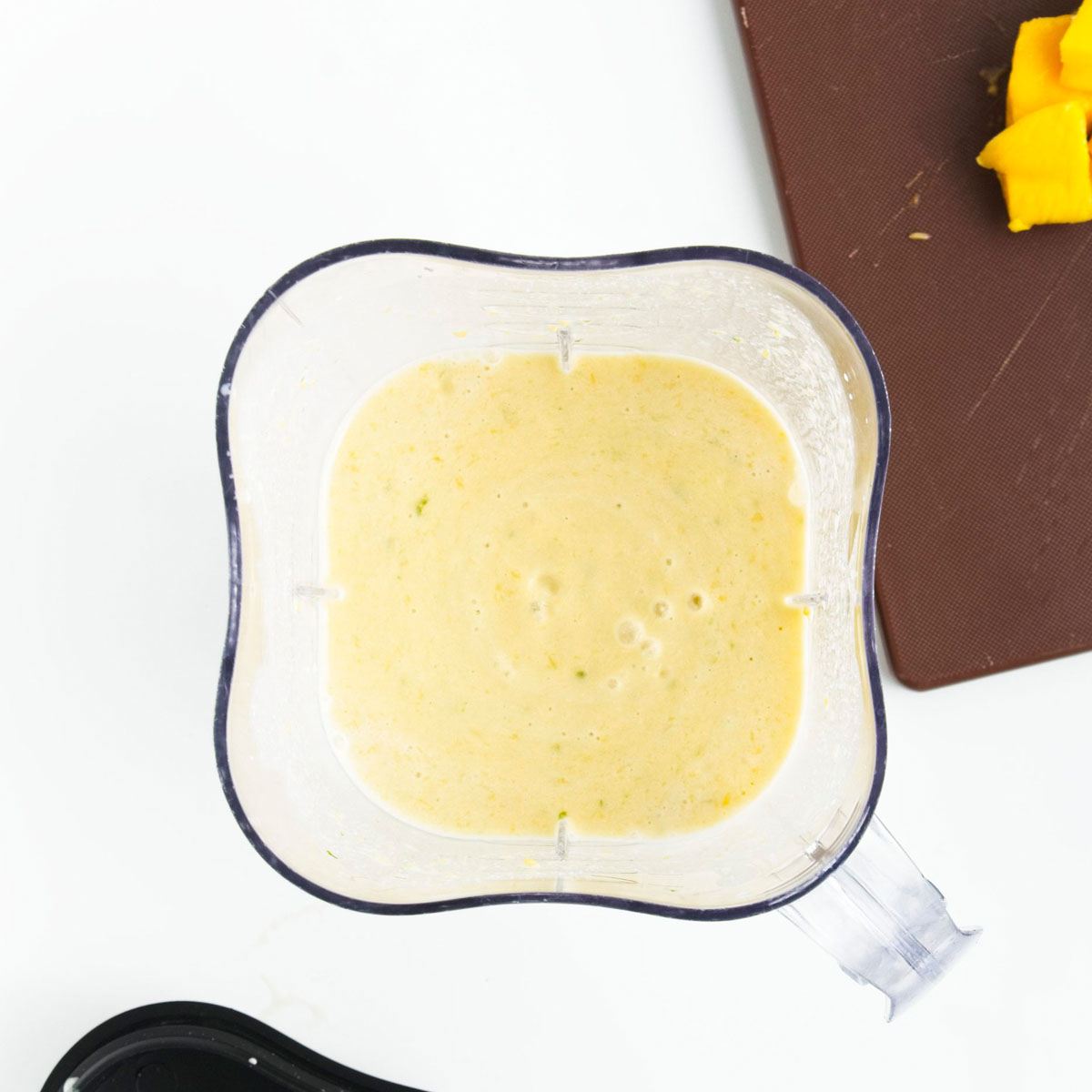 Blender with a yellow creamy puree.