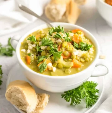 Small white bowl of yellow stew with split peas, carrots, and sweet potatoes
