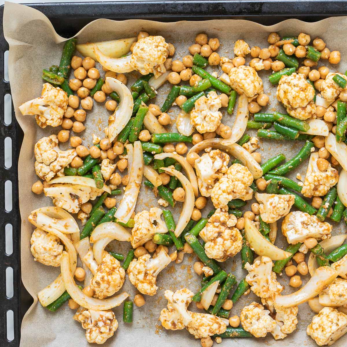 Sheet pan with fresh cauliflower florets, green beans and chickpeas
