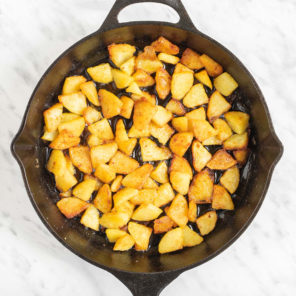 Skillet with diced potatoes.