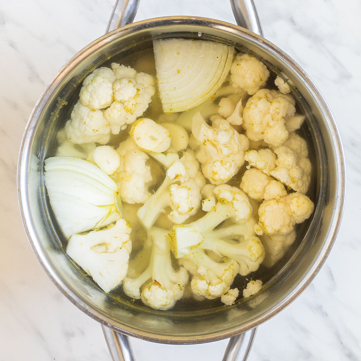 Stock with onion and cauliflower florets.