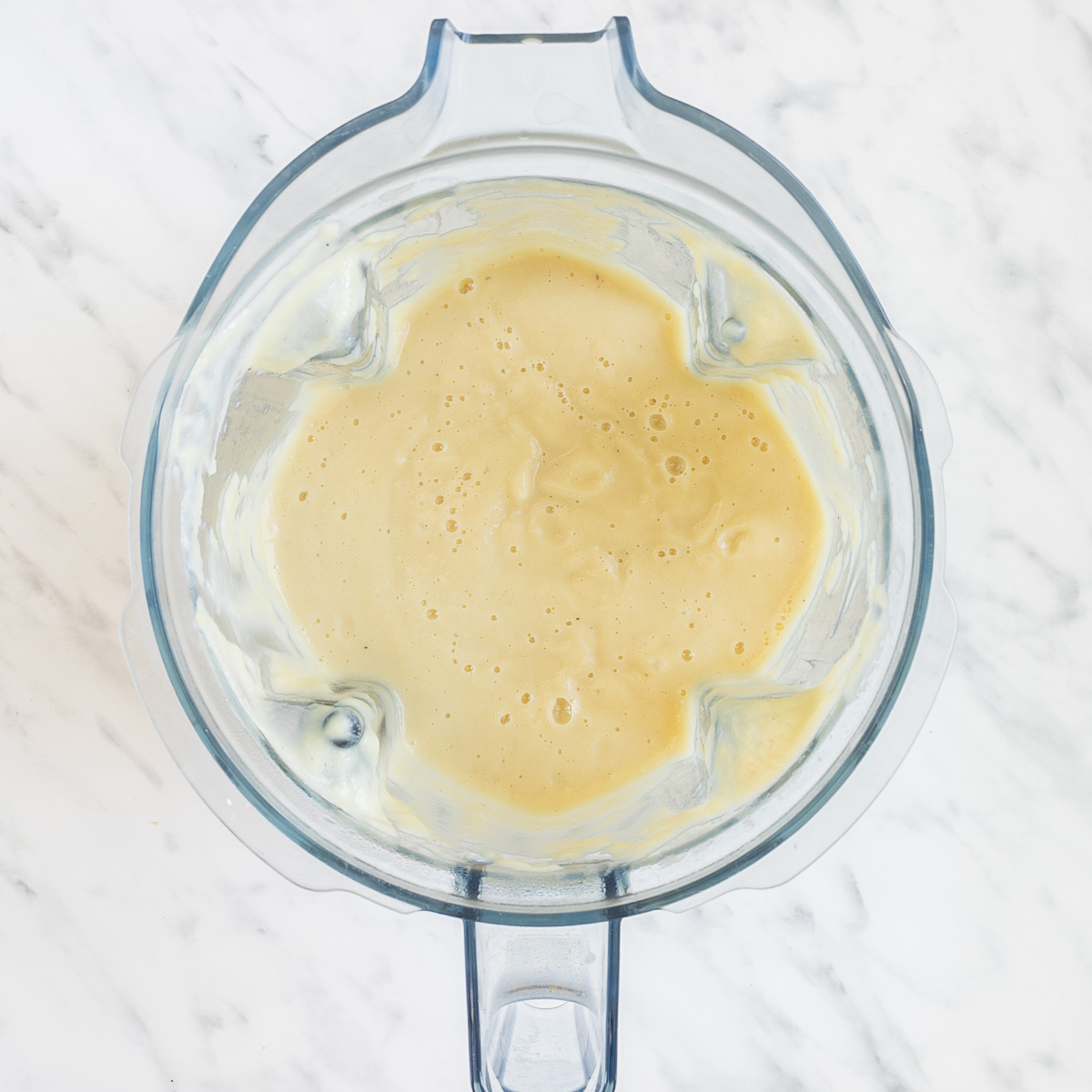 Blender with a light brown creamy sauce.