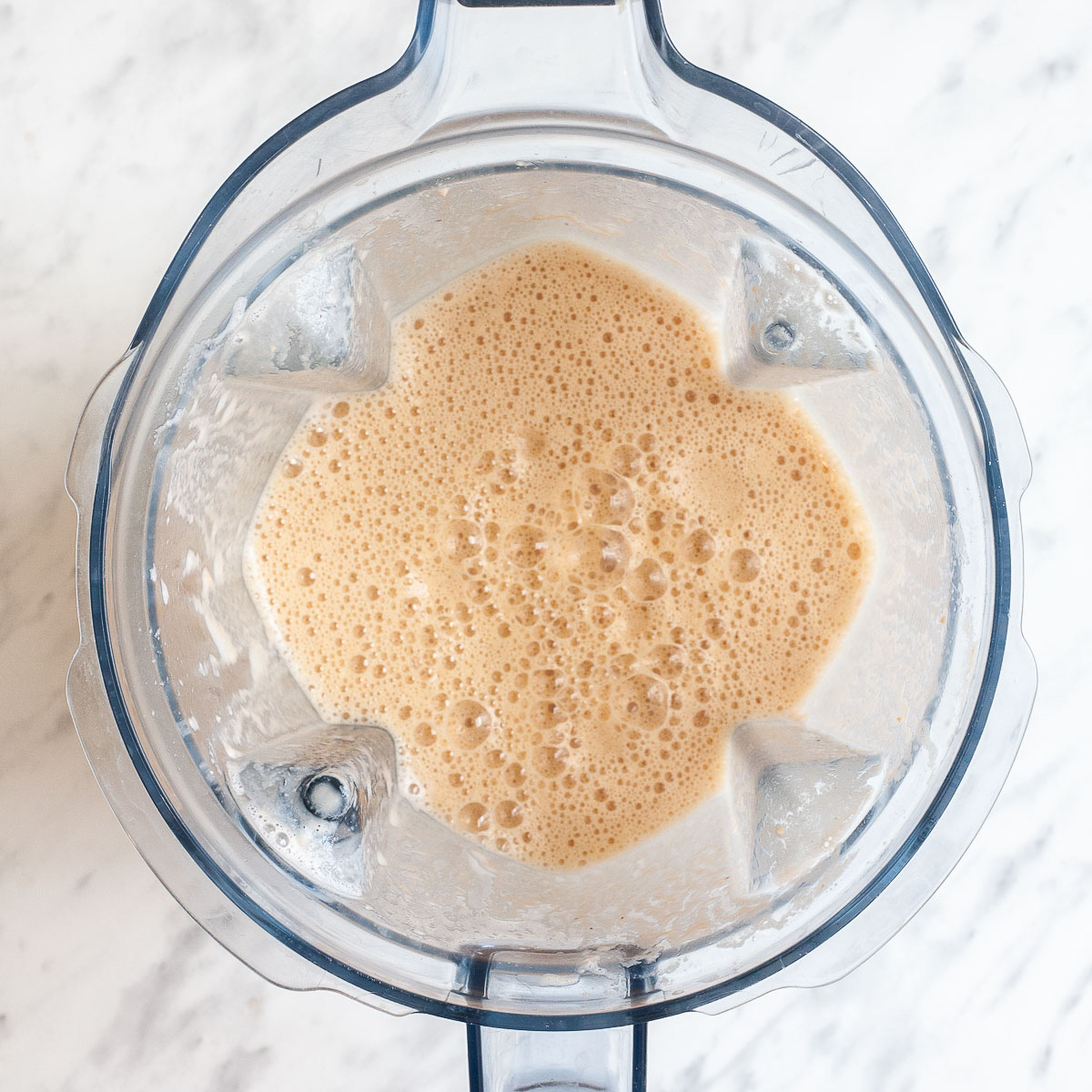 Blender with orange liquid.