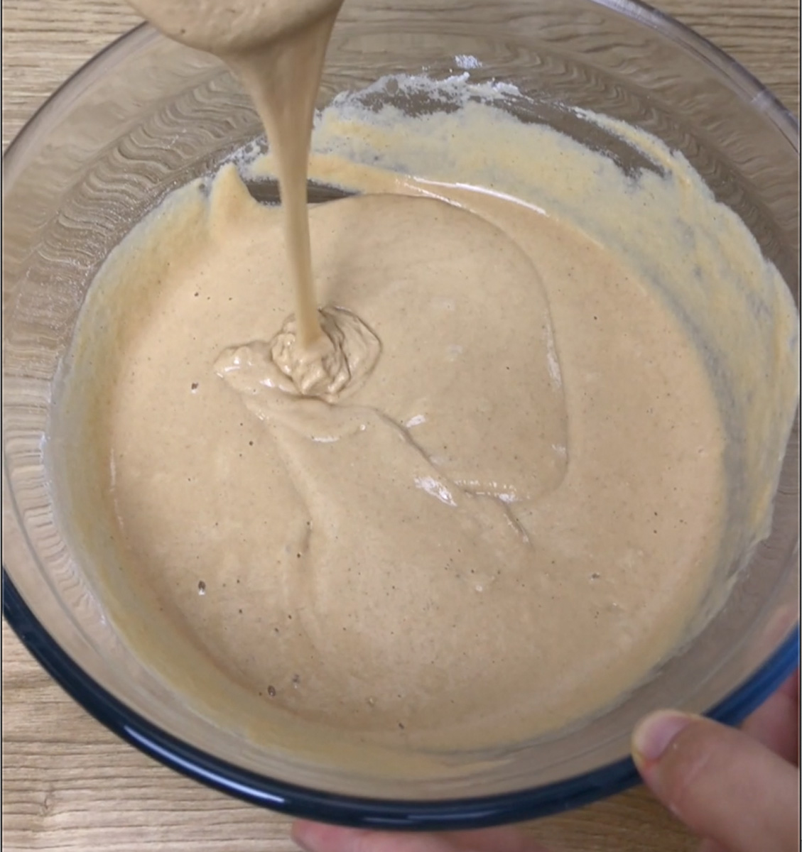 Glass bowl with thick brownish pancake batter.
