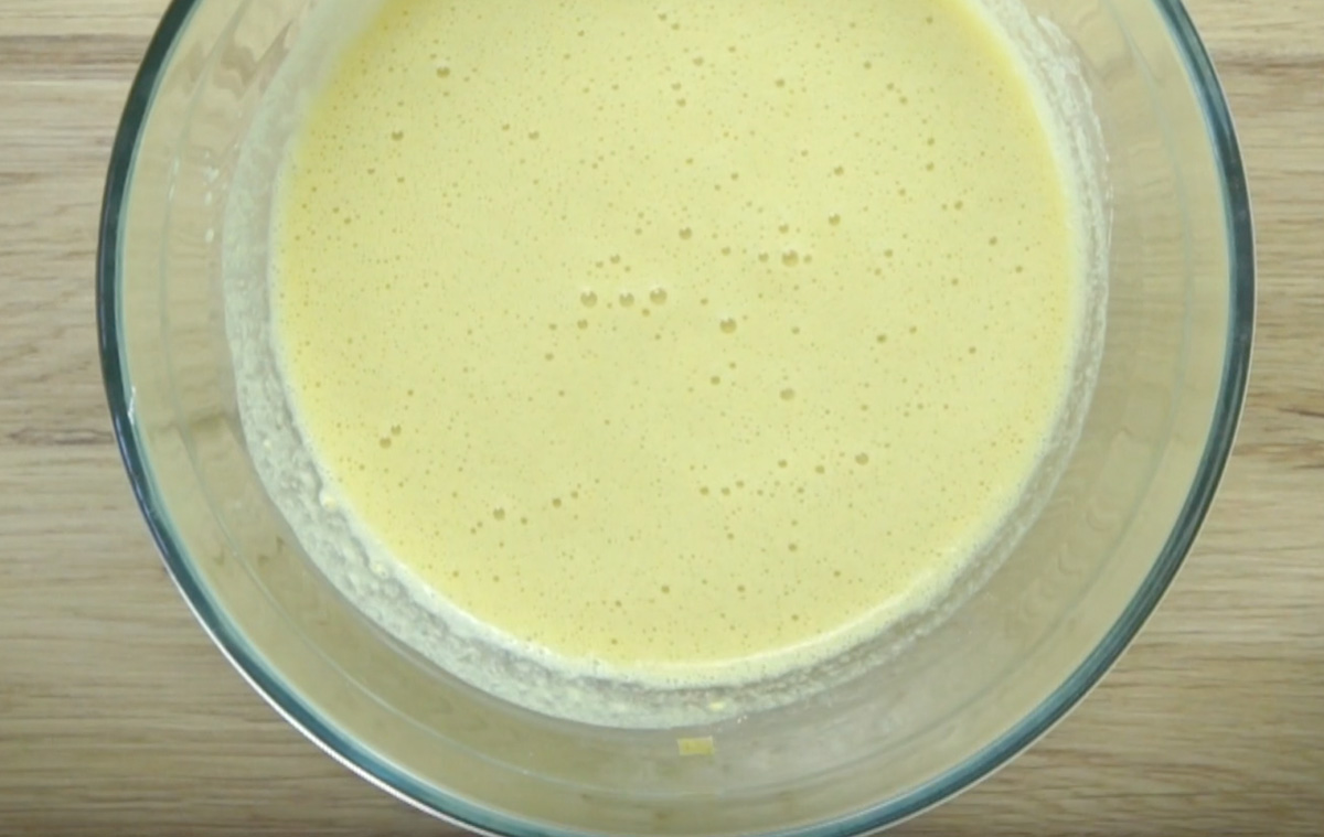 Glass bowl with yellow batter.