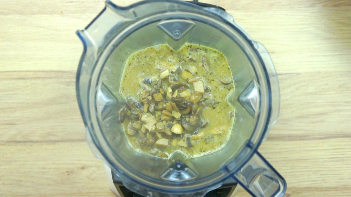 Blender with brown mushroom soup and mushroom slices
