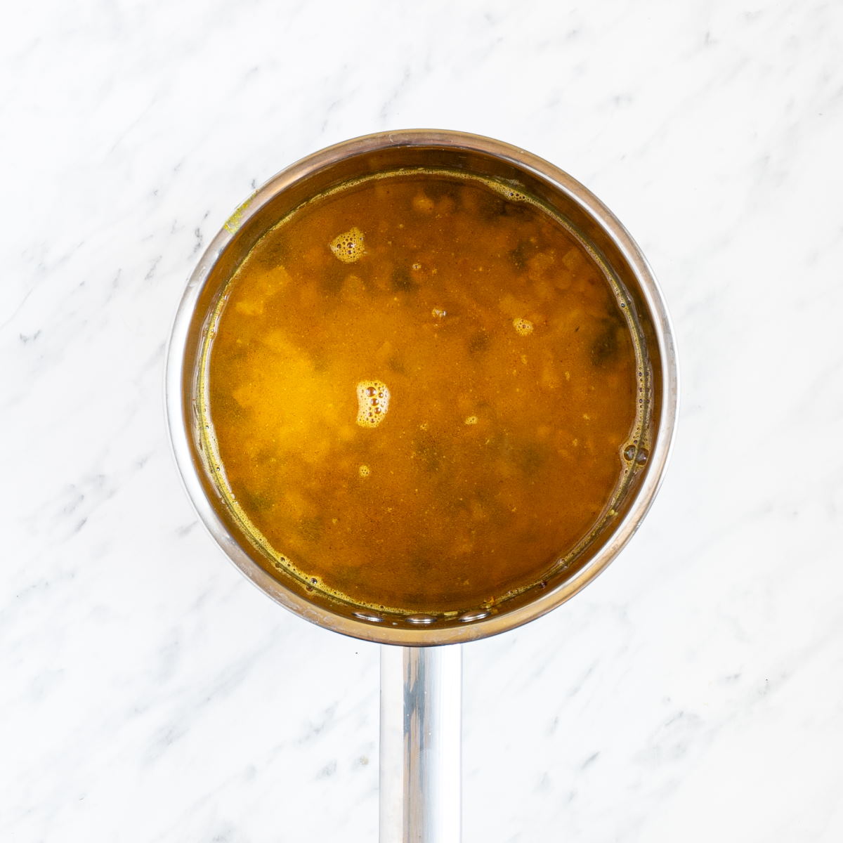 Pan with orange liquid.