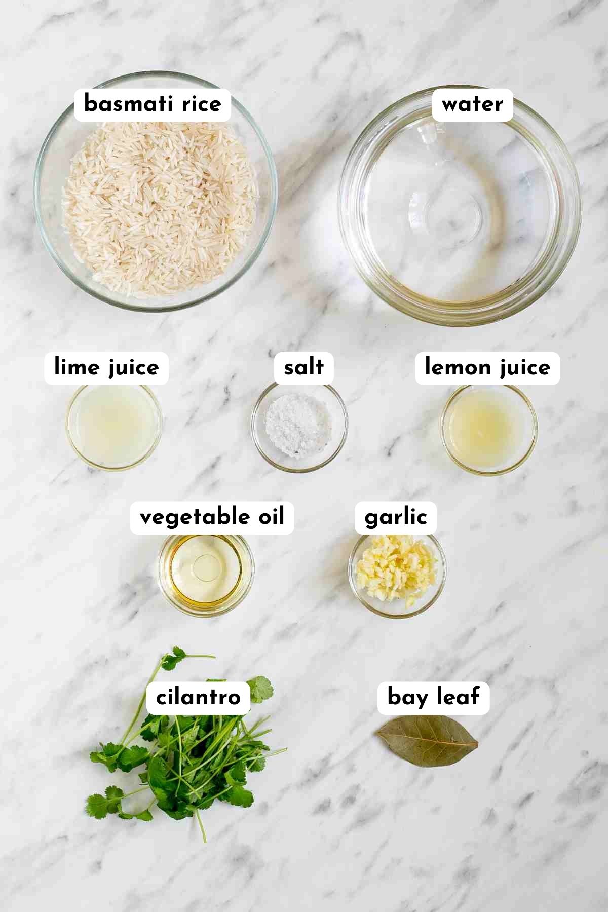 The ingredients of cilantro lime rice in small glass bowls like rice, water, lime jouce, oil, minced garlic, bay leaf, and cilantro. 
