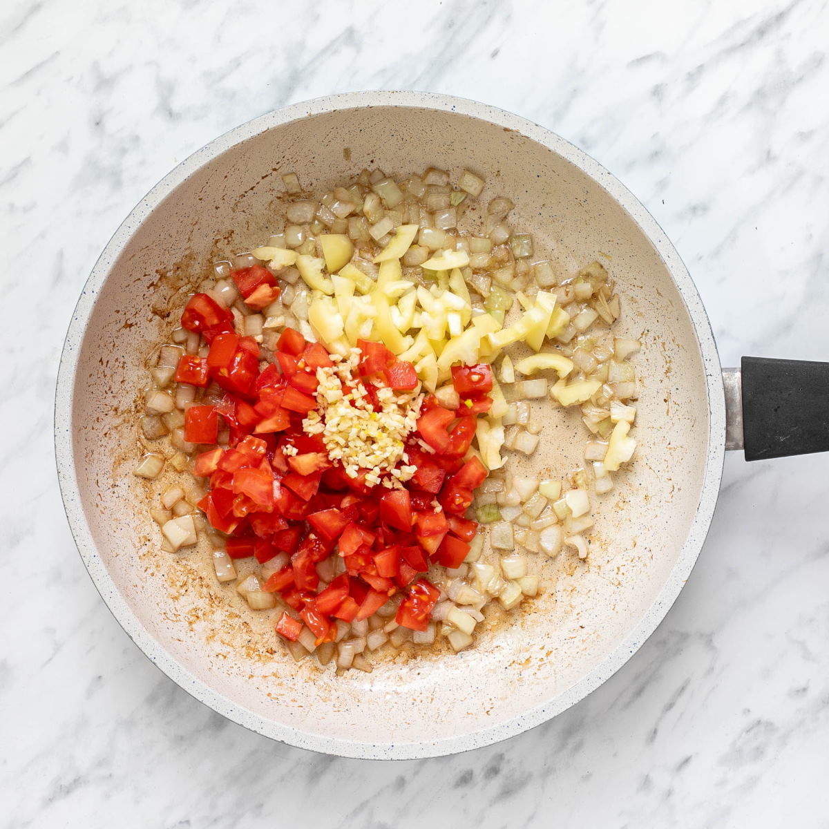 Sauteed onions with chopped tomatoes, Hungarian peppers and garlic.