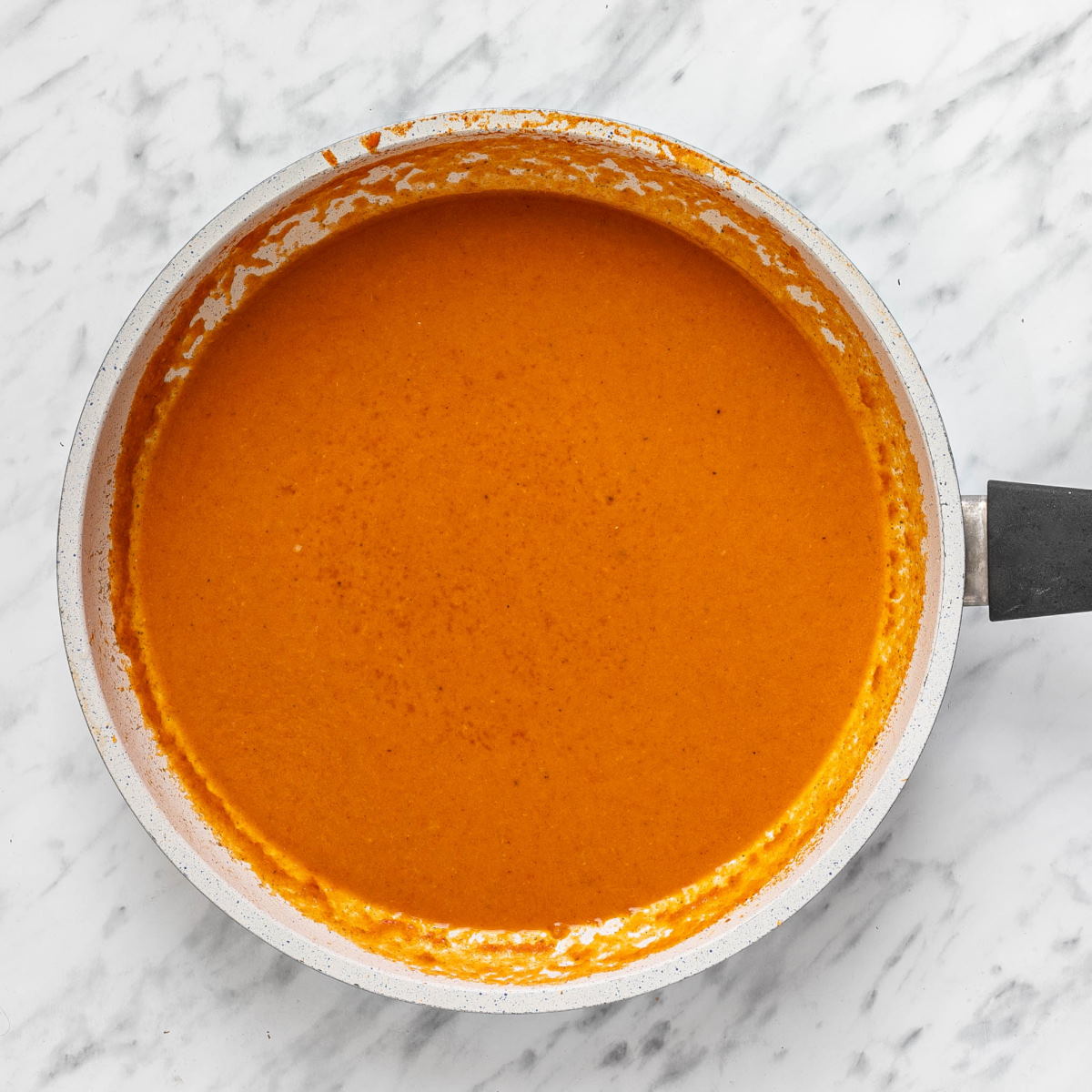 An overhead shot of smooth and thick mushroom stew sauce in a pan.