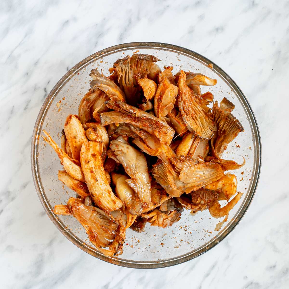 Shredded mushrooms in redish marinade.