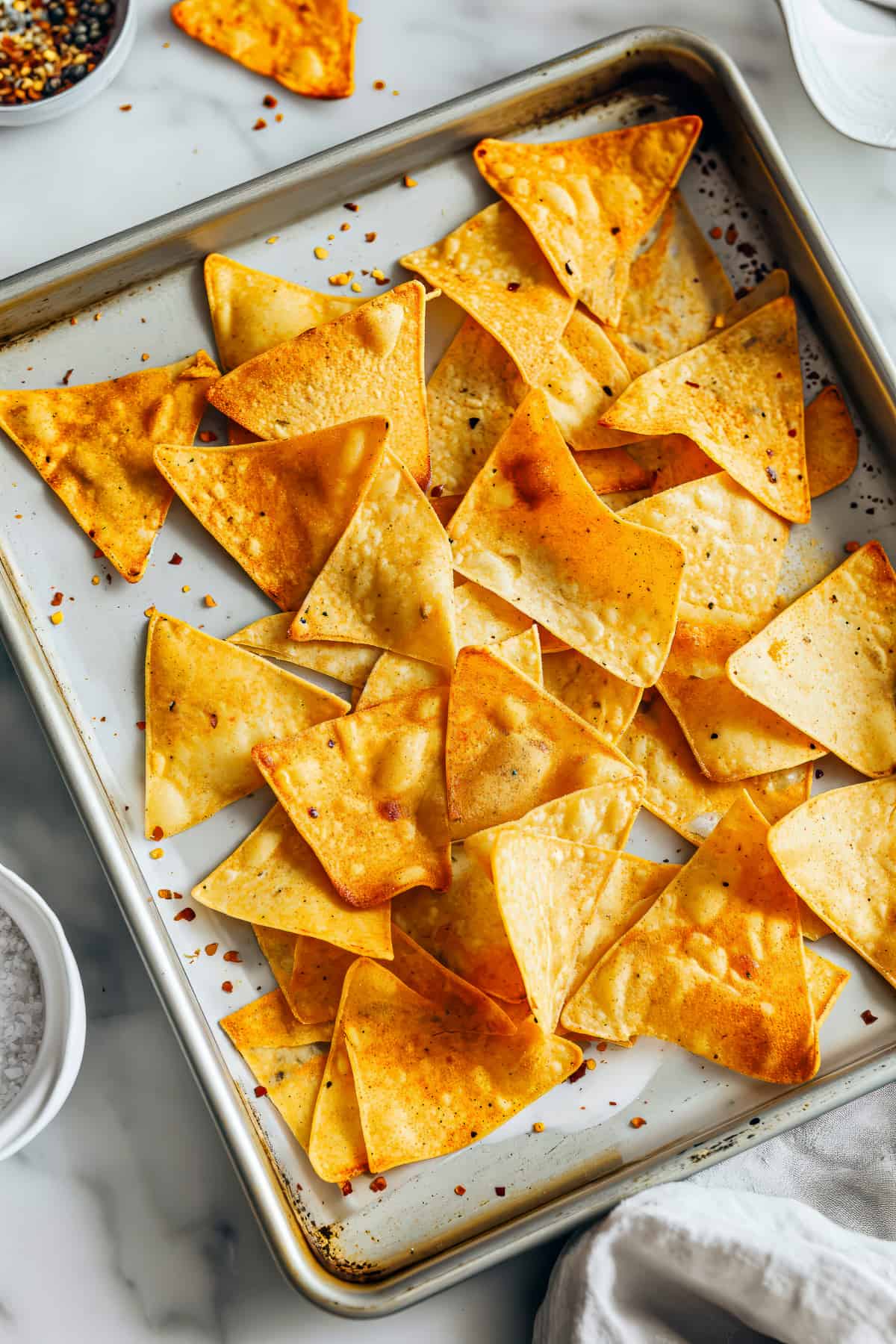 Whole grain tortilla chips on a baking sheet.