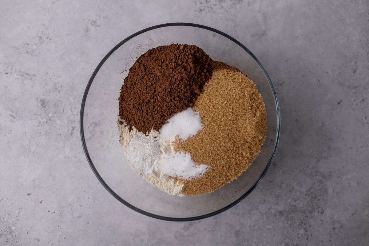 Glass bowl with cocoa powder, cane sugar, and flour.