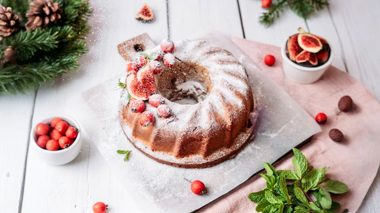 a bundt cake with icing and berries on it
