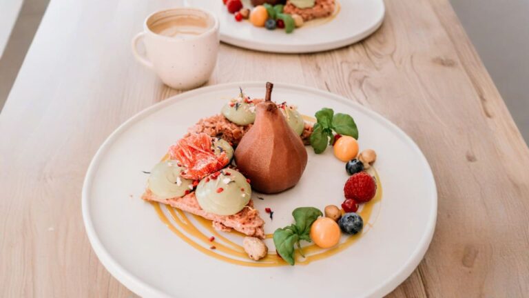 a white plate topped with fruit and a pear