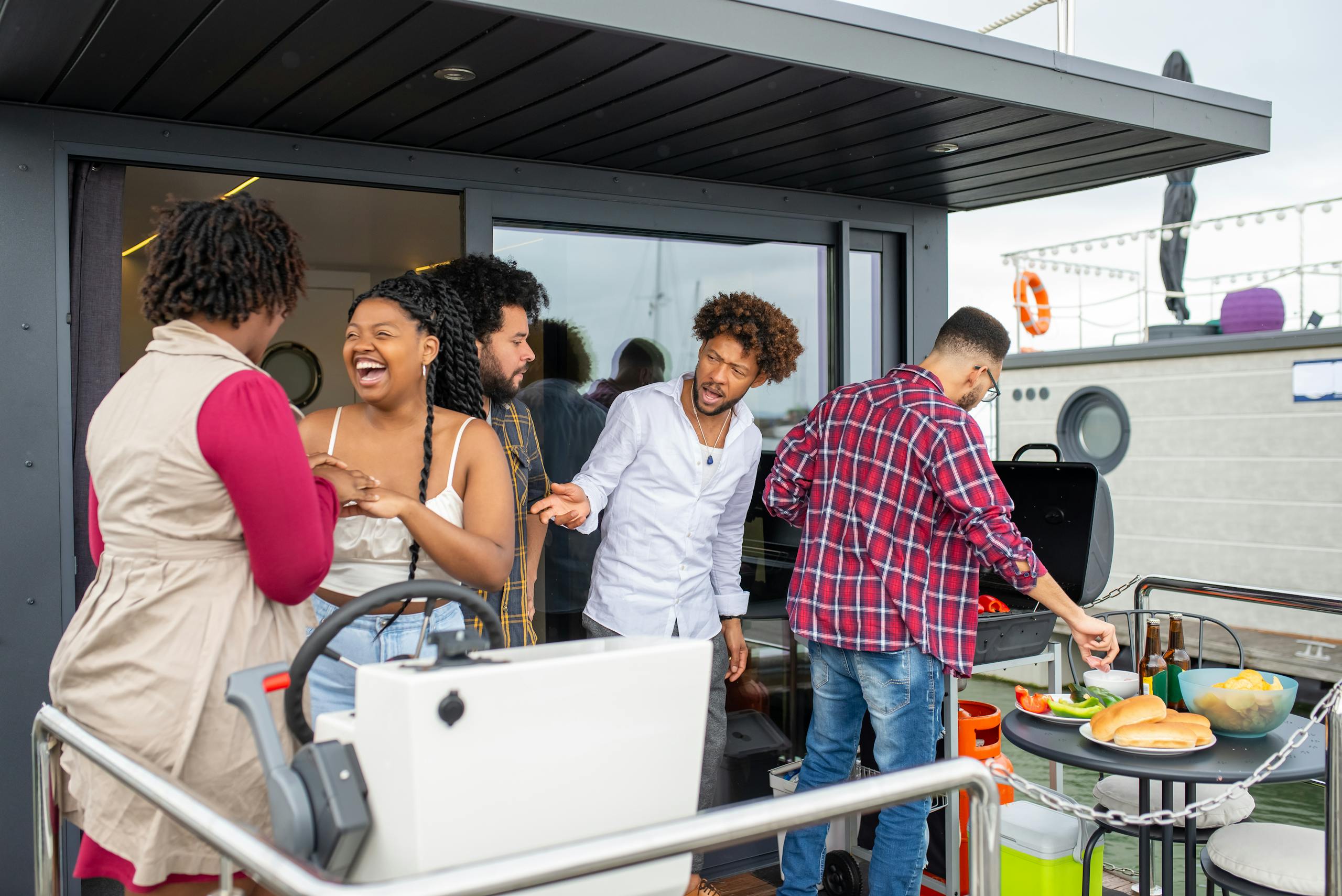A lively group of friends enjoying a barbecue outdoors on a stylish patio.