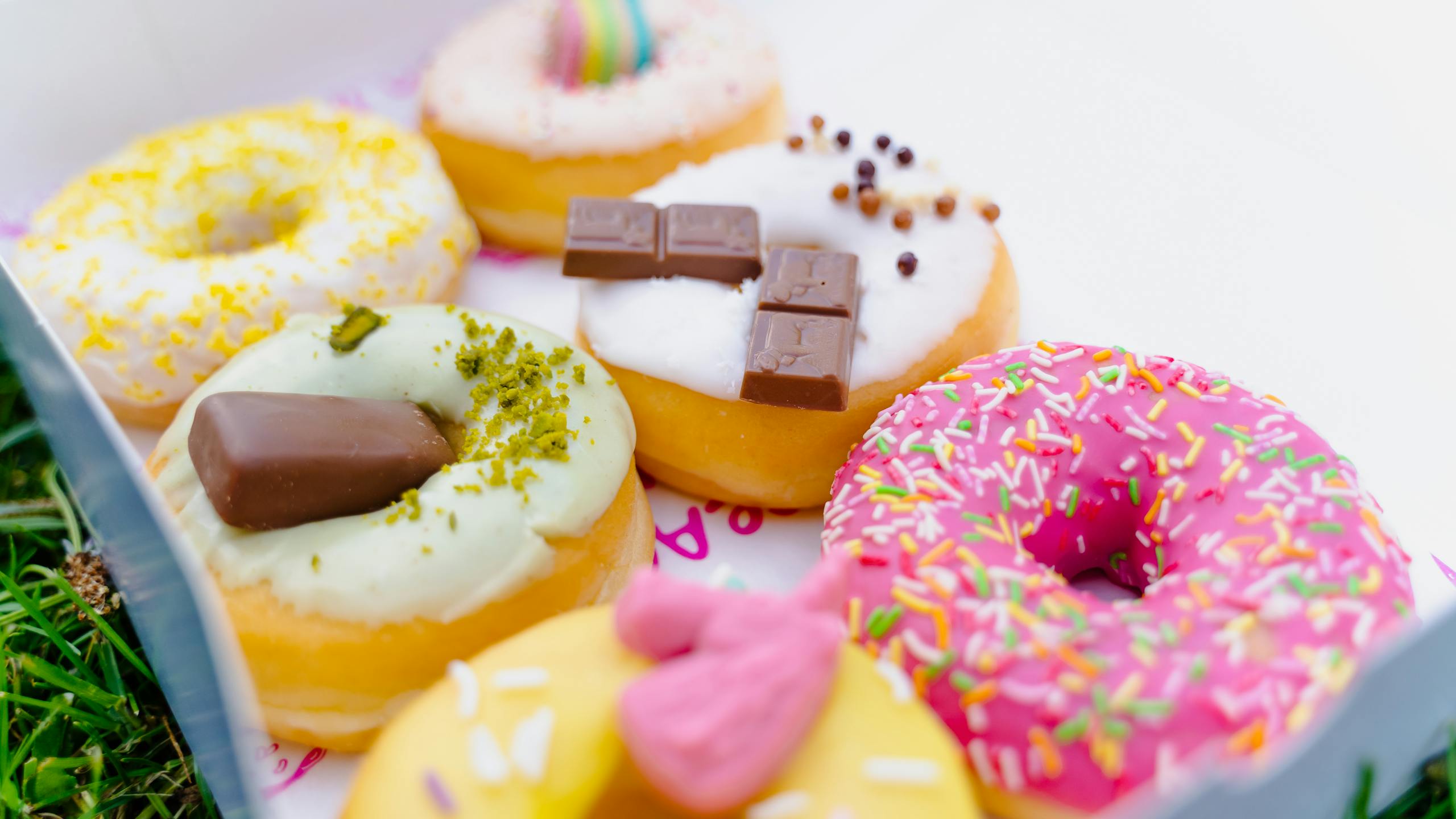 Delicious assorted donuts with colorful toppings, perfect for dessert lovers.